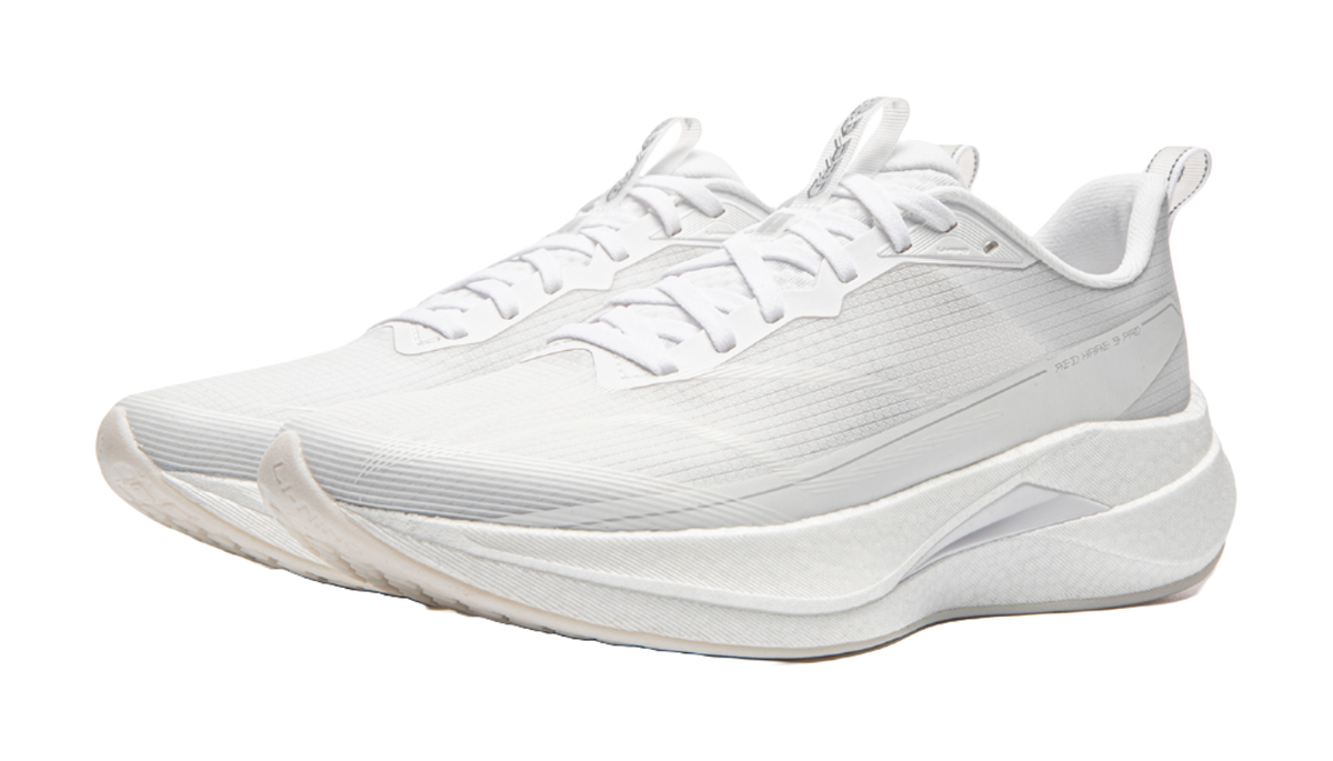 White running shoe with lace-up front and thick rocker-style sole