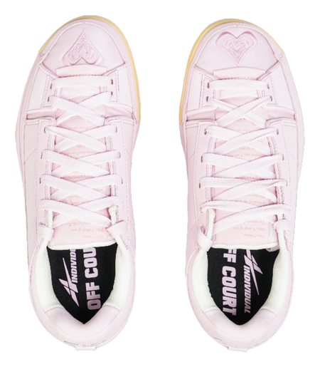 Pink low-top sneakers with white laces and black sockliner graphic at heel