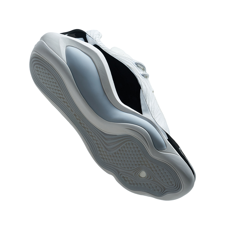 White and black basketball shoe outsole, side view with textured tread