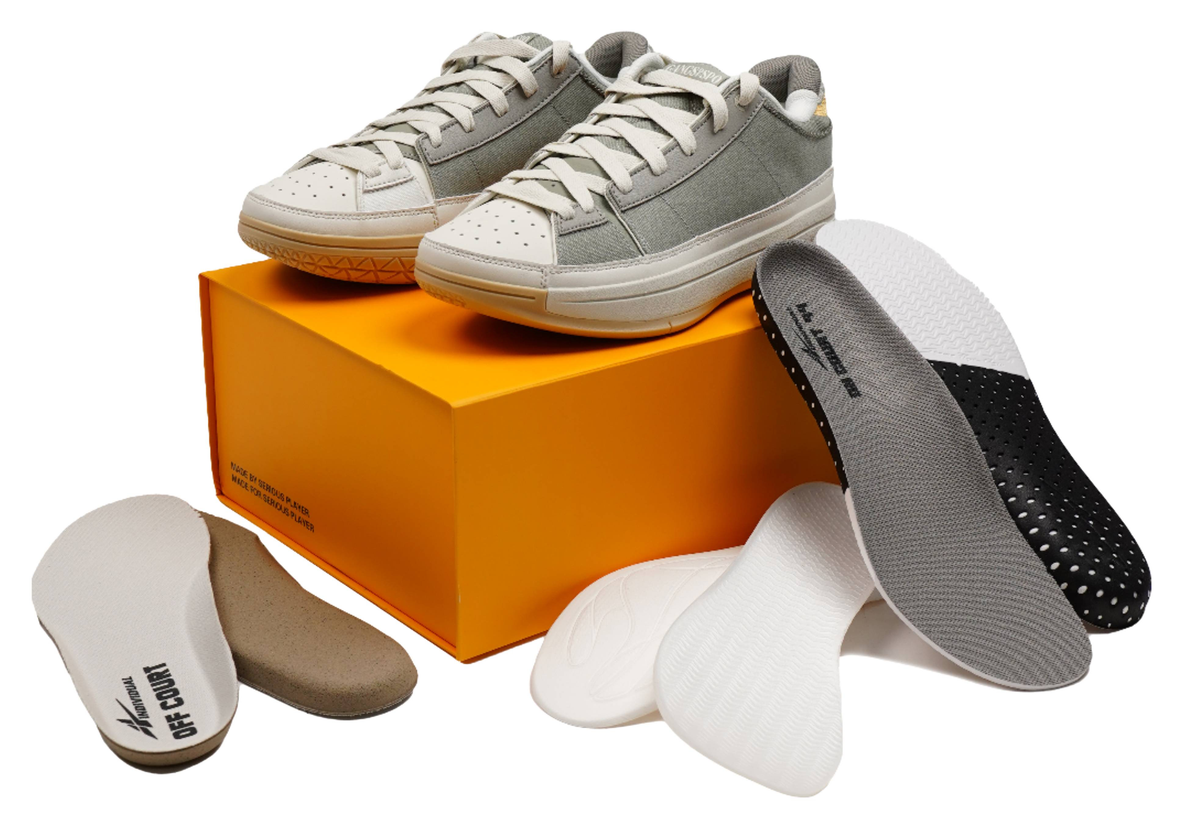 Unisex basketball shoes on an orange box with spare insoles and socks