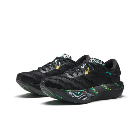 Women’s black running shoes with green accents, lace-up, textured mesh upper, graphic sole.
