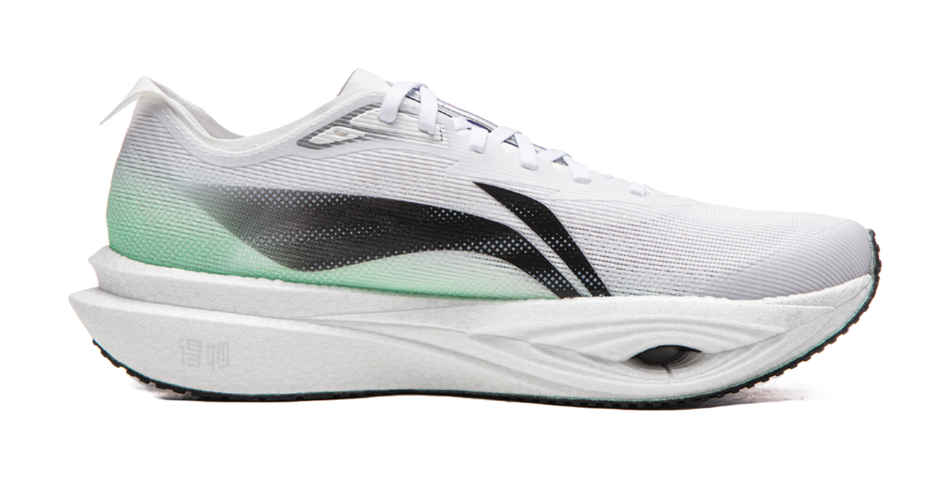 White running shoe with green heel panel, black side stripe, laced mesh upper, thick sole
