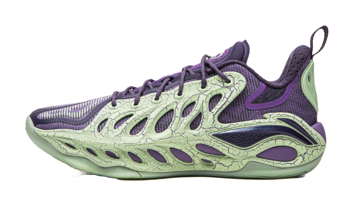 Purple and green basketball shoe with lace-up front, textured upper panels