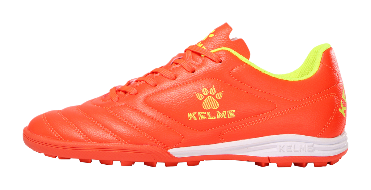 Orange unisex training soccer shoes with lace-up front and KELME logo, synthetic upper