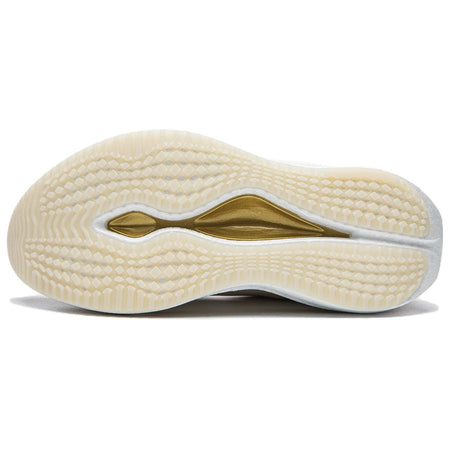 Running shoe outsole in light beige with patterned tread and gold logo stripe.