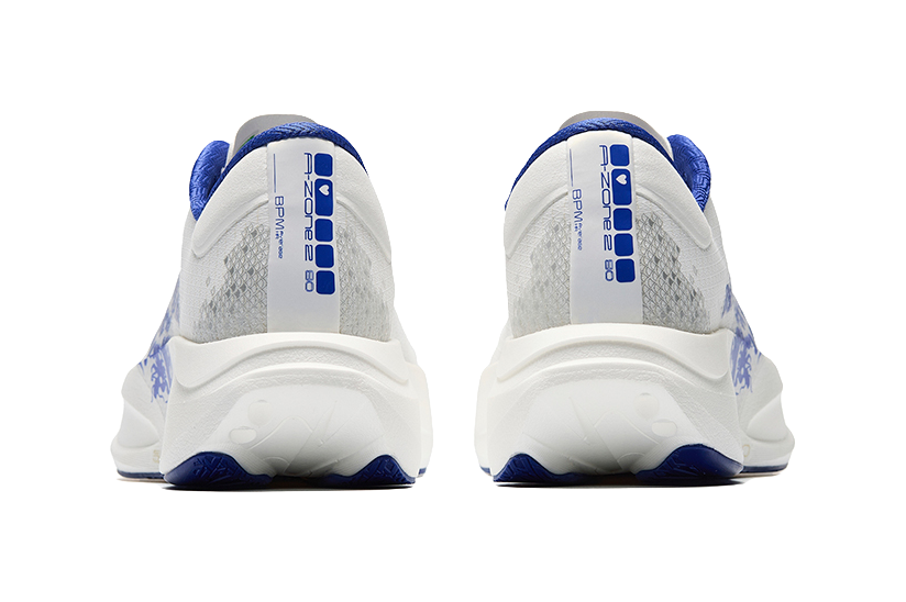 Rear view of white-and-blue low-top running sneakers with heel branding and tabs