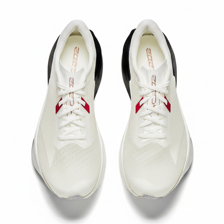 Pair of white running shoes with black heel lining, red strap detail, and lace-up uppers