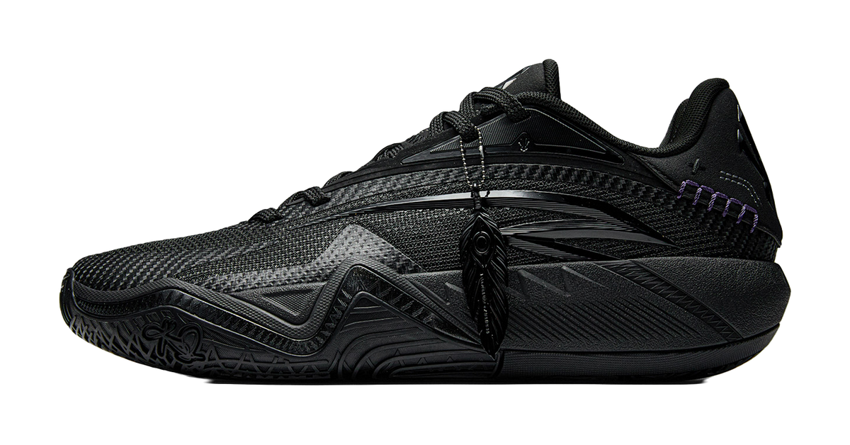 Black basketball shoe with lace-up front, mesh upper, purple trim and sculpted midsole