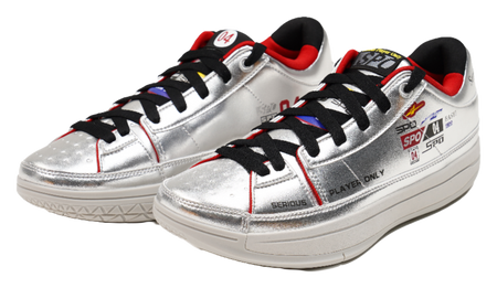 Silver basketball shoes with black laces, red collar lining, thick white sole