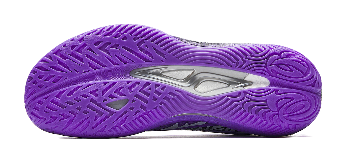 Purple basketball shoe outsole with molded tread pattern and traction side grooves.