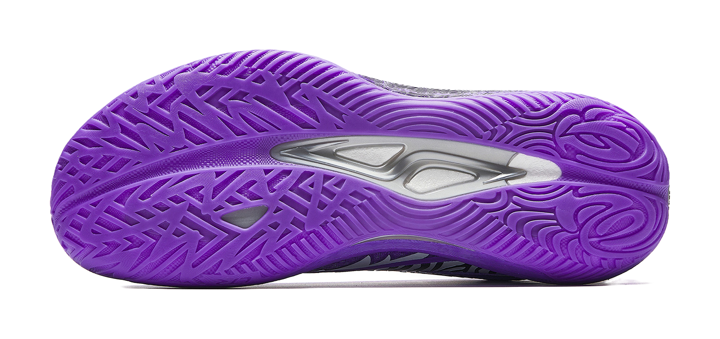 Purple basketball shoe outsole with molded tread pattern and traction side grooves.