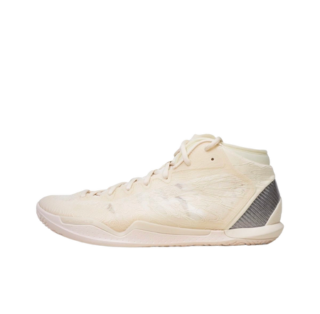 Mid basketball shoe in cream-white with lace-up, textured upper, and dark side panel