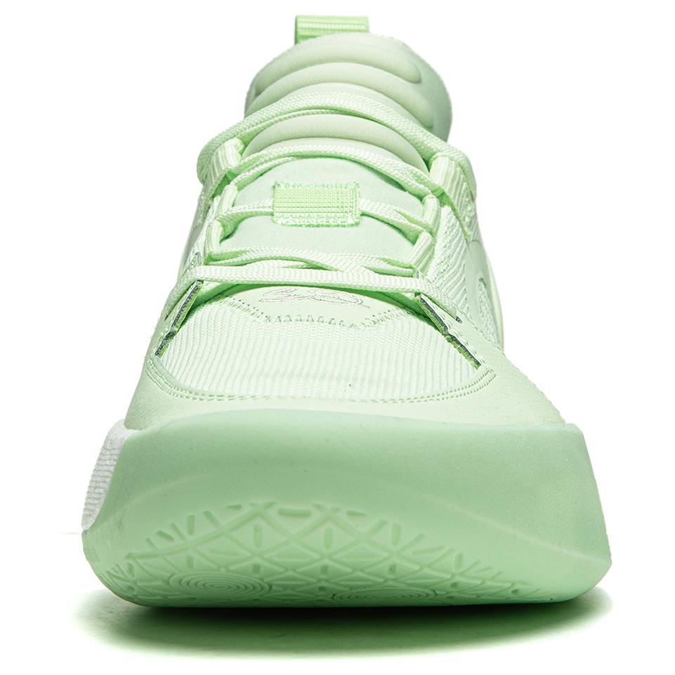 Agile green basketball shoe close-up of toe and laces, textured upper, grippy sole.