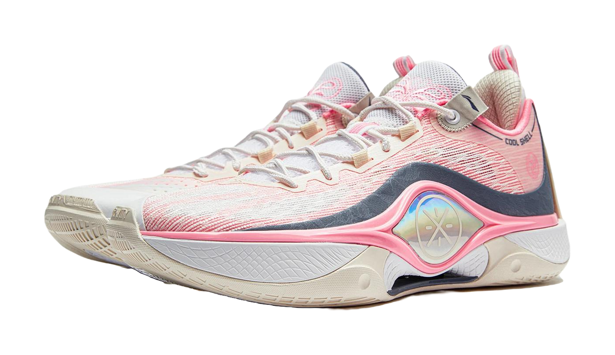 Basketball shoe in white and pink with dark blue overlays and arched forefoot stripe