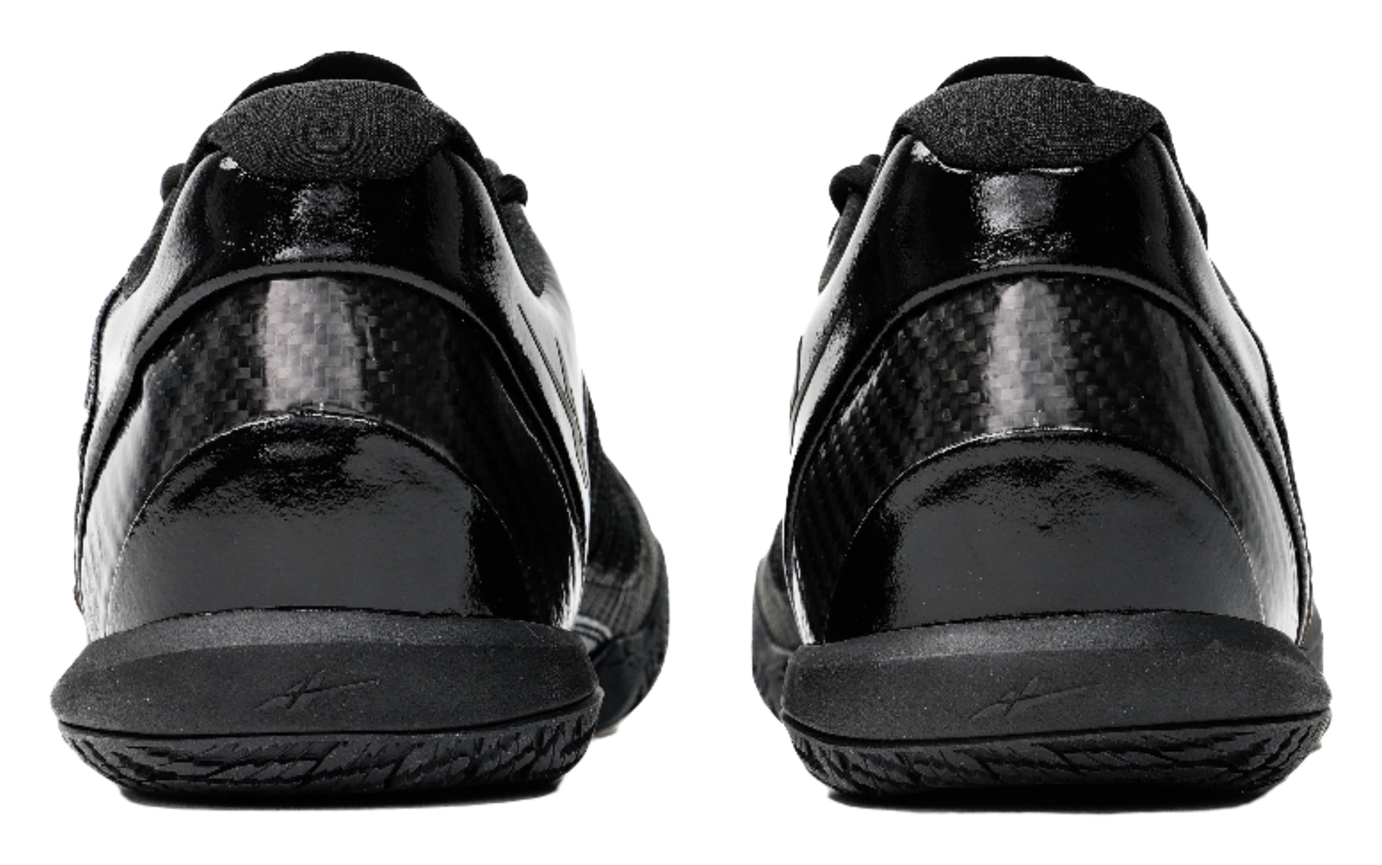 Black low-top basketball shoes, rear view with cushioned heel and lace collar.