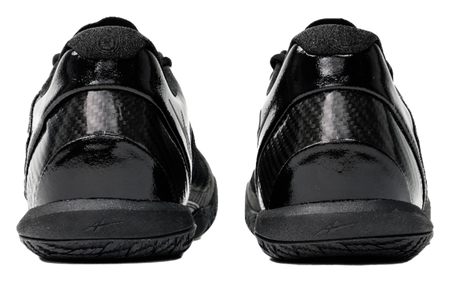 Black low-top basketball shoes, rear view with cushioned heel and lace collar.