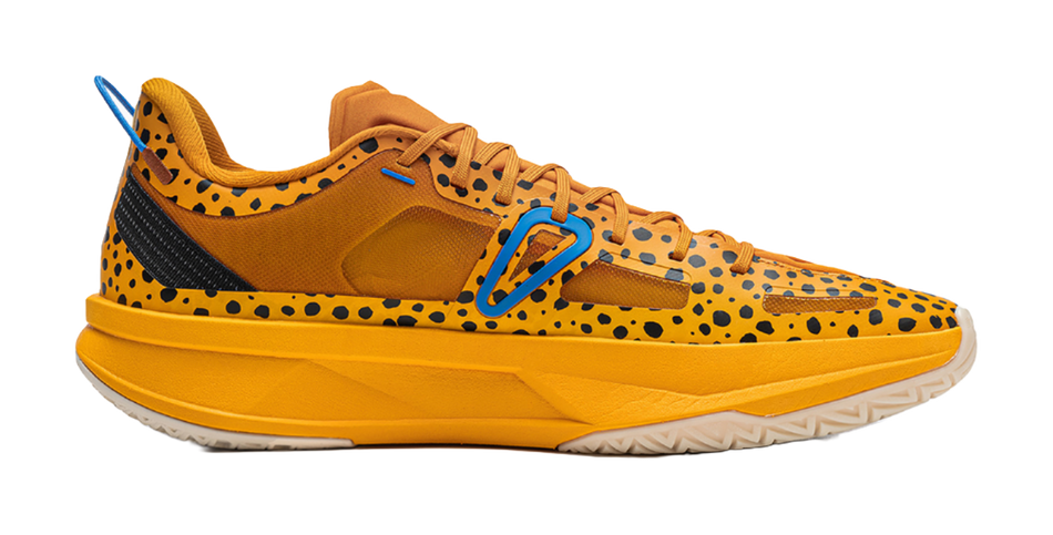 Men's low-top basketball shoe with orange upper, blue swoosh, and black speckle design