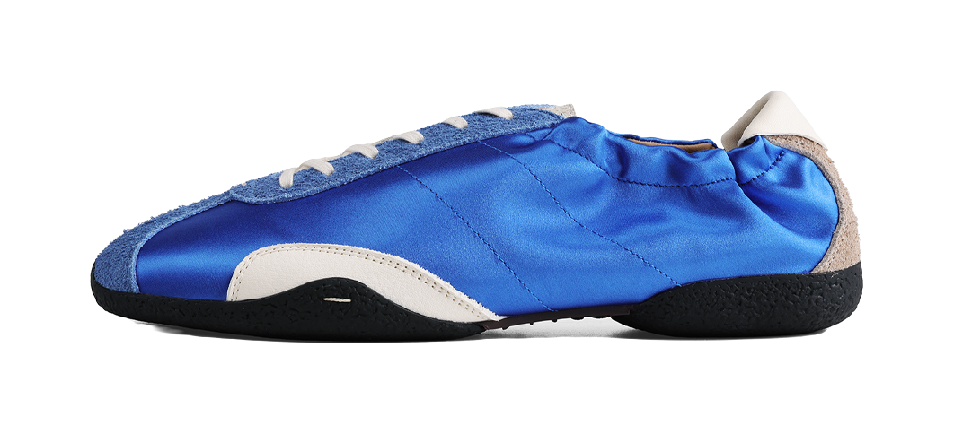 Blue low-top ballet training shoe with beige lining and stitched canvas upper