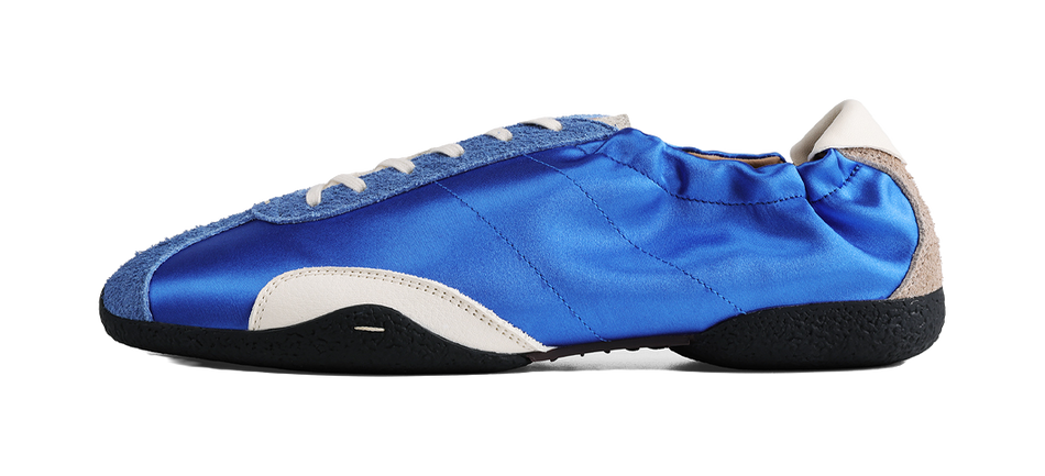 Blue low-top ballet training shoe with beige lining and stitched canvas upper