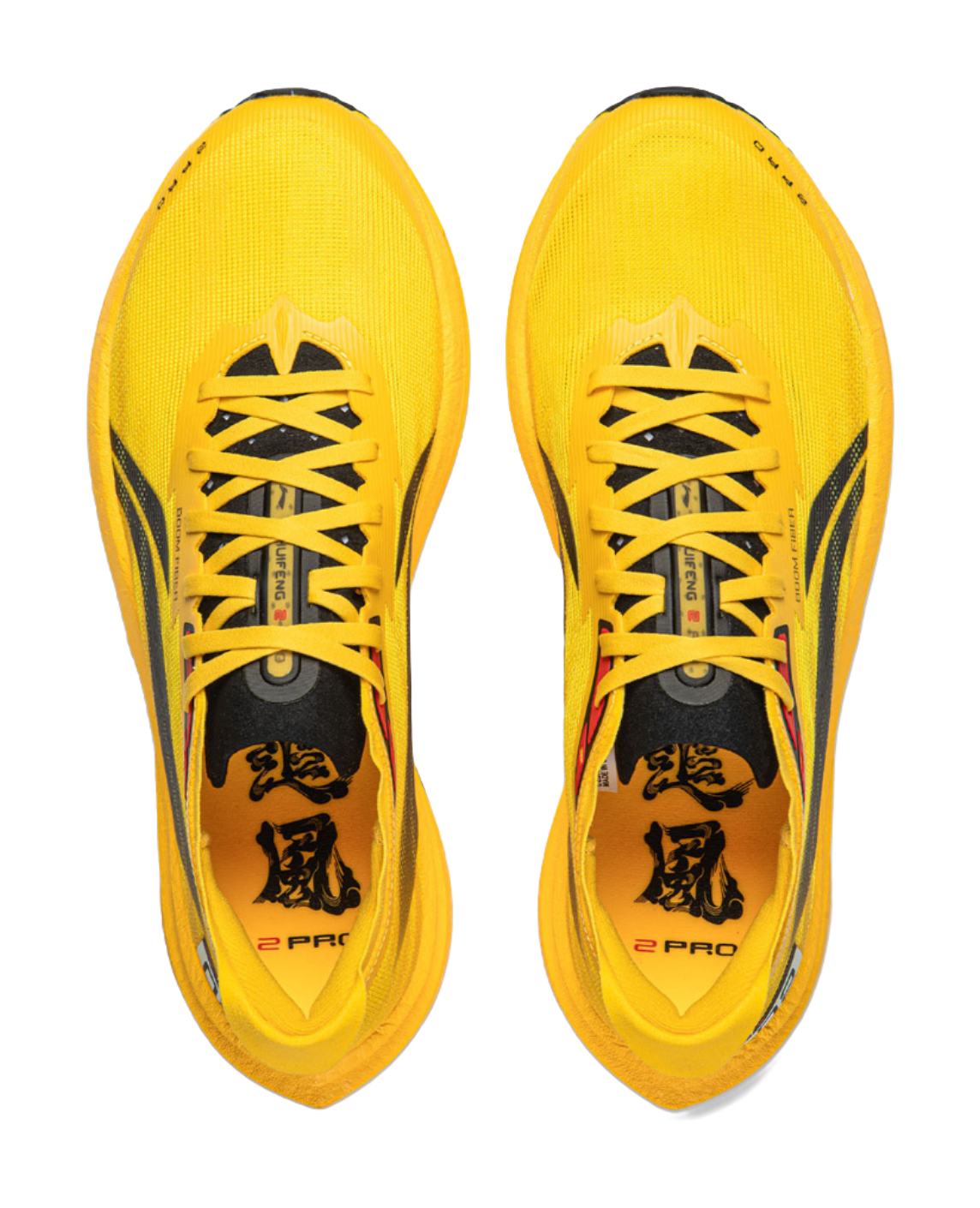 Pair of yellow low-top running shoes with black laces and patterned tongue label.