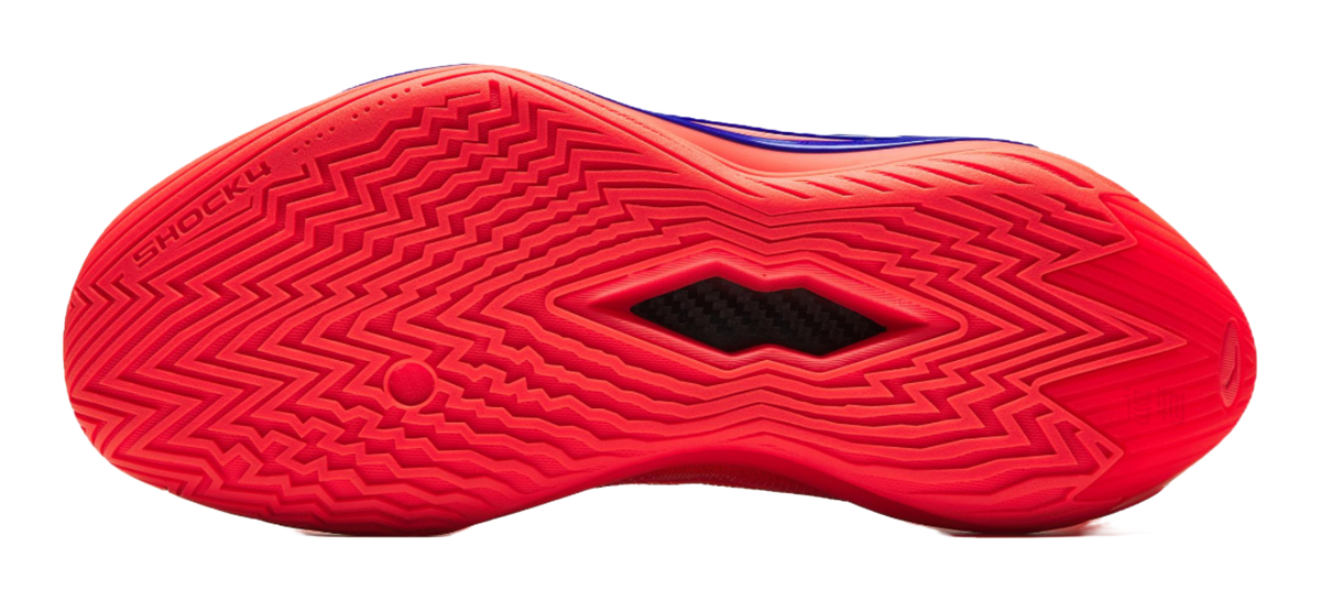 Red basketball shoe outsole close-up with zigzag tread pattern and brand text