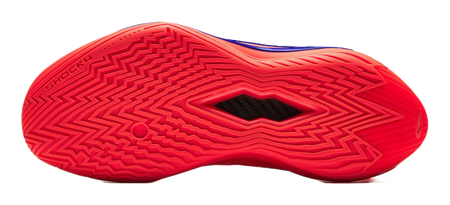 Red basketball shoe outsole close-up with zigzag tread pattern and brand text