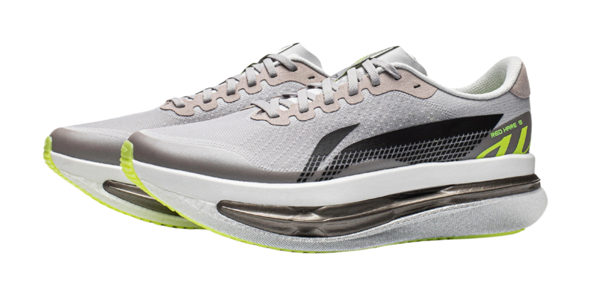 Men's low-top running shoes with gray textured mesh, black side, and lime outsole edge