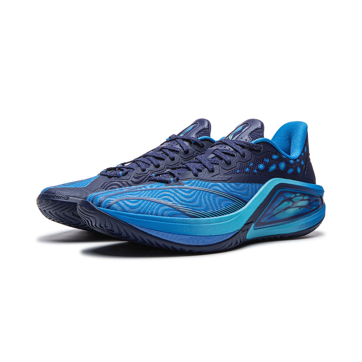 Men's basketball shoe with lace-up navy upper and bright blue heel collar, side profile
