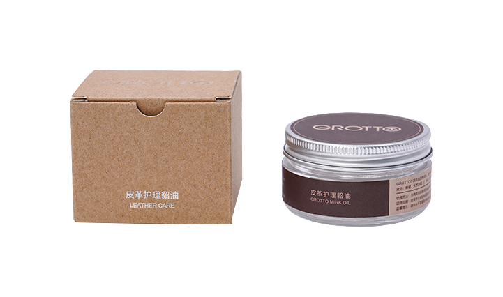 Leather care cream jar and brown cardboard box labeled for leather care.