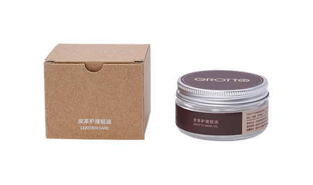 Leather care cream jar and brown cardboard box labeled for leather care.