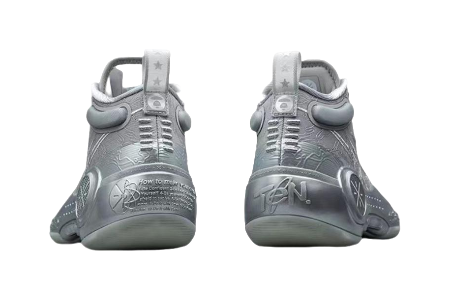 Gray mid-top basketball shoes with rear pull tab and lace-up closure, branding on heel.