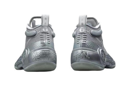 Gray mid-top basketball shoes with rear pull tab and lace-up closure, branding on heel.