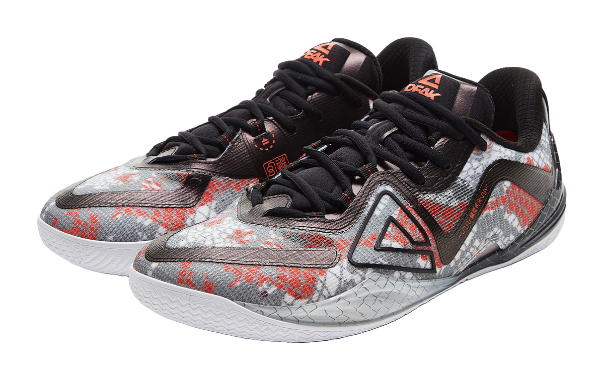 Angled basketball shoe with speckled fabric, black laces, red and gray details
