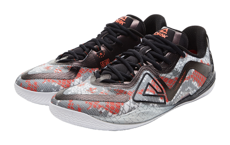 Angled basketball shoe with speckled fabric, black laces, red and gray details