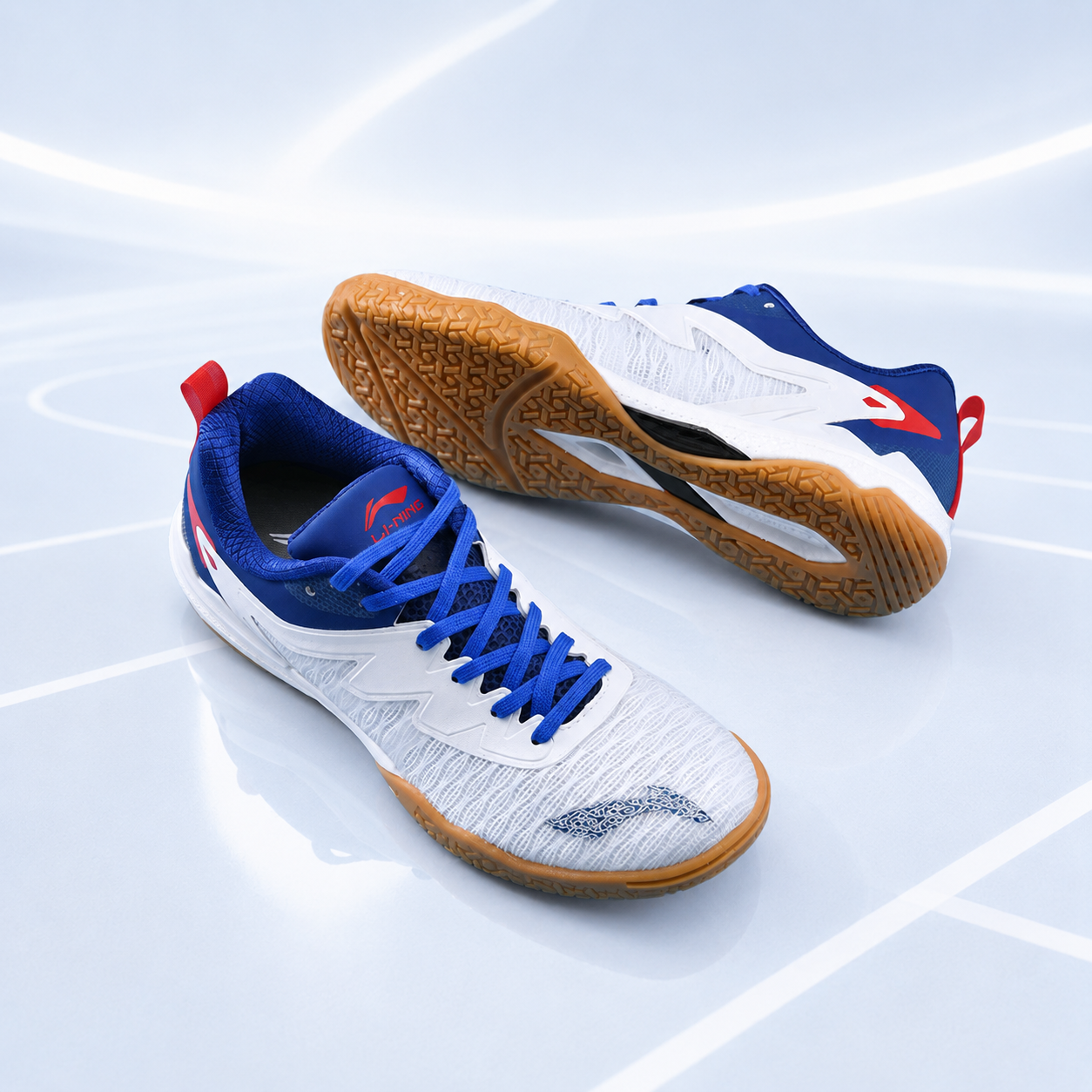 Unisex table tennis shoes on court lines: white uppers with blue laces and gum soles.