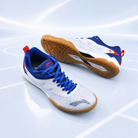Unisex table tennis shoes on court lines: white uppers with blue laces and gum soles.