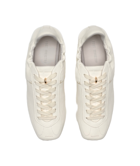 Antique white low-top trainers, front-facing pair with lace hooks and cushioned collar