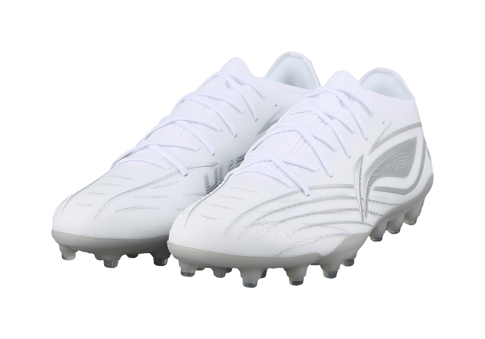 White silvery soccer cleat pair, angled front view, studs visible.
