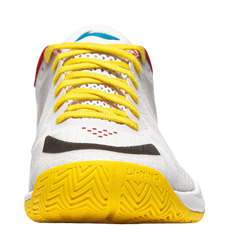White table tennis shoe with yellow laces and yellow textured outsole tread