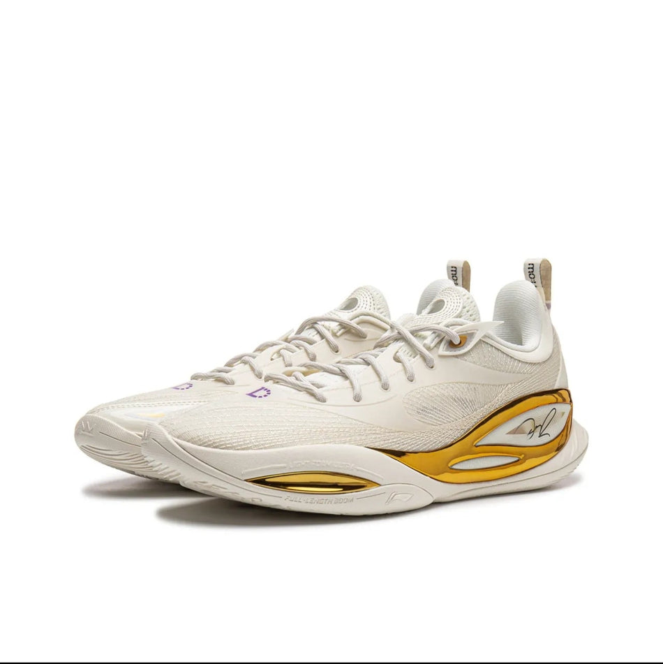 Light silver/white basketball shoe with lace-up front and gold side emblem.
