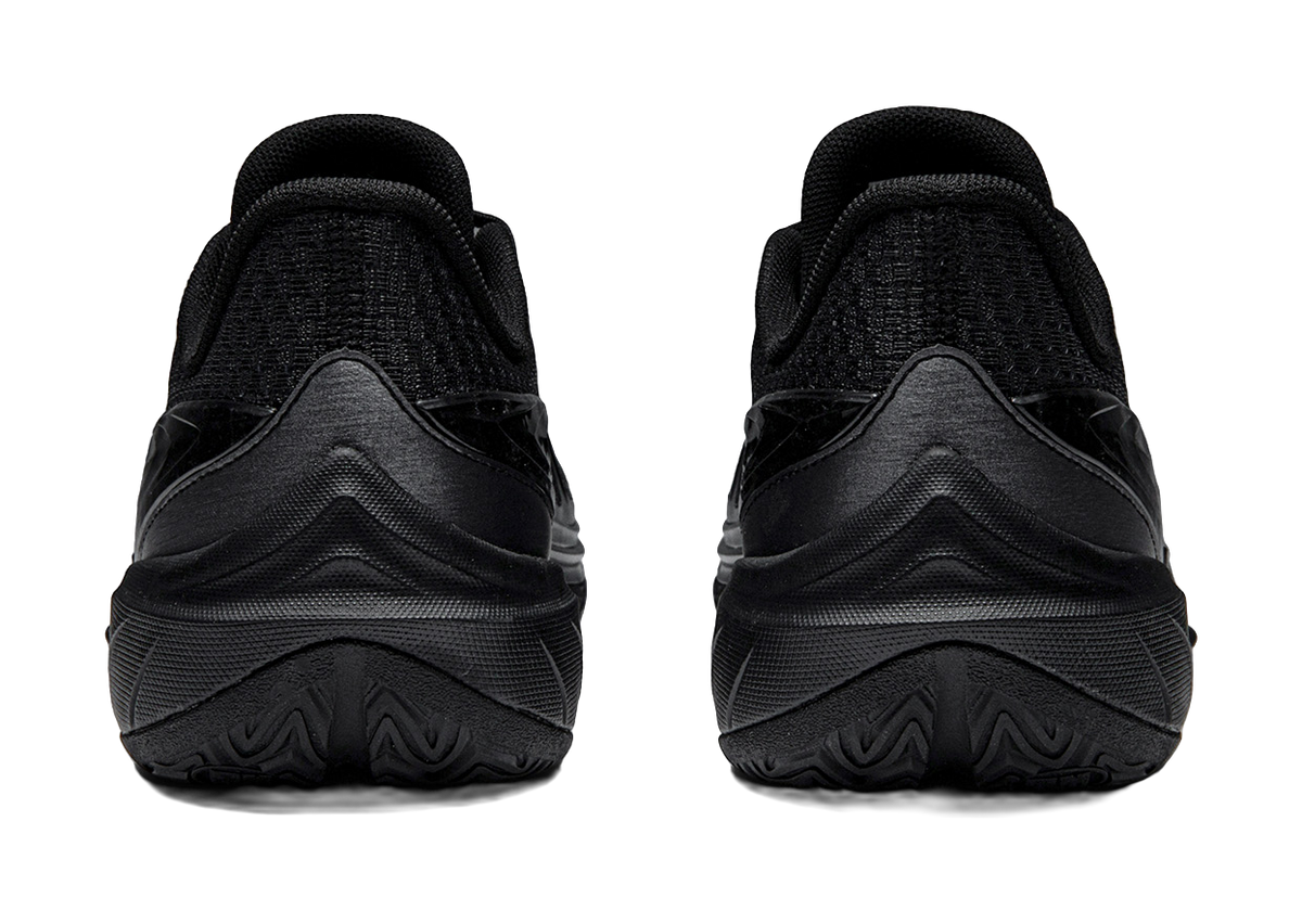 Black low-top basketball shoes heel view with padded collar and treaded sole