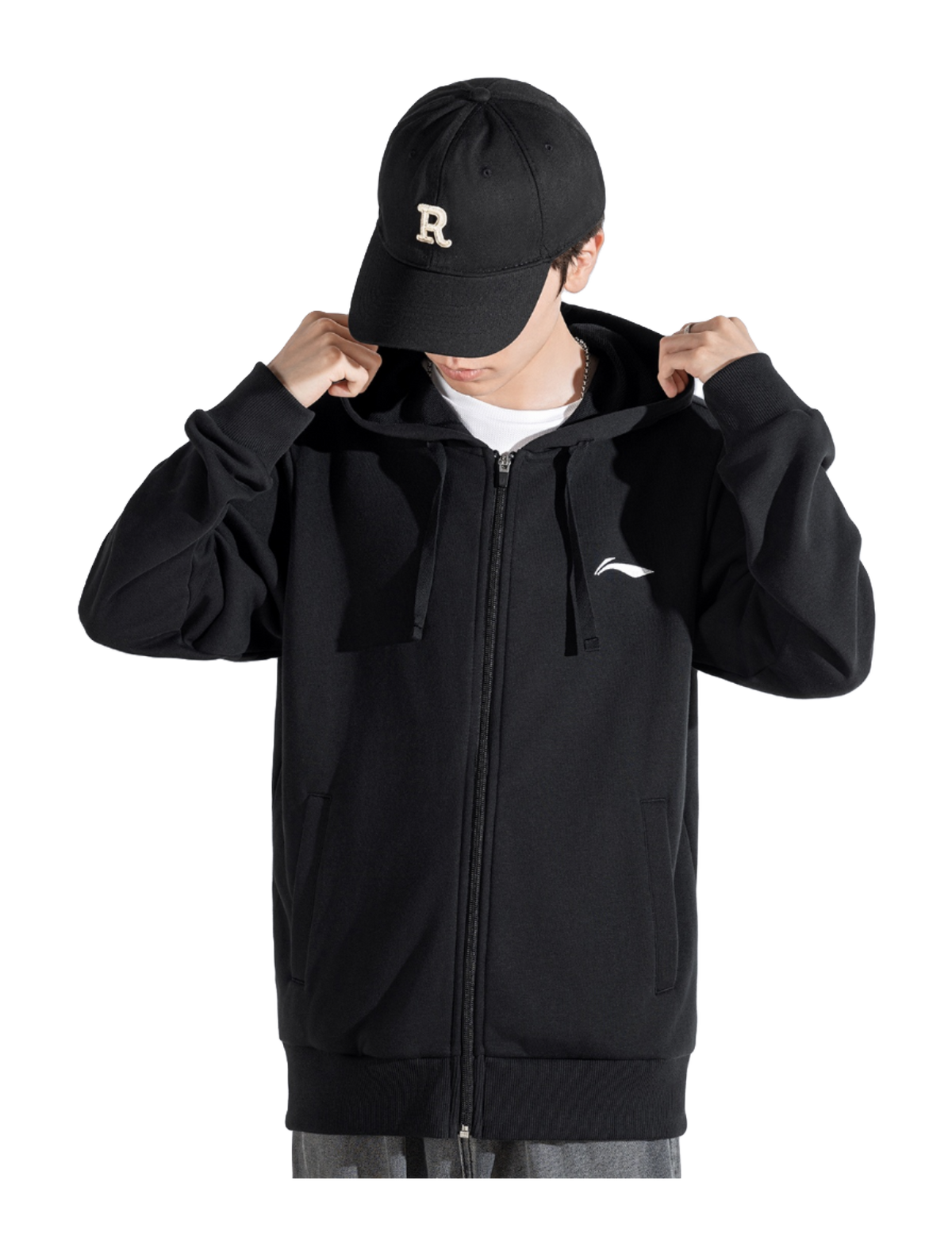 Men’s black zip-up hooded sweatshirt with drawstring, worn with black cap, full front zipper