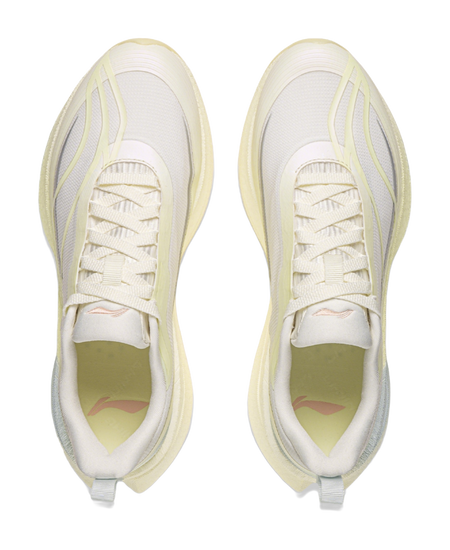 Pair of women's low-top running shoes with off-white laces and mesh uppers