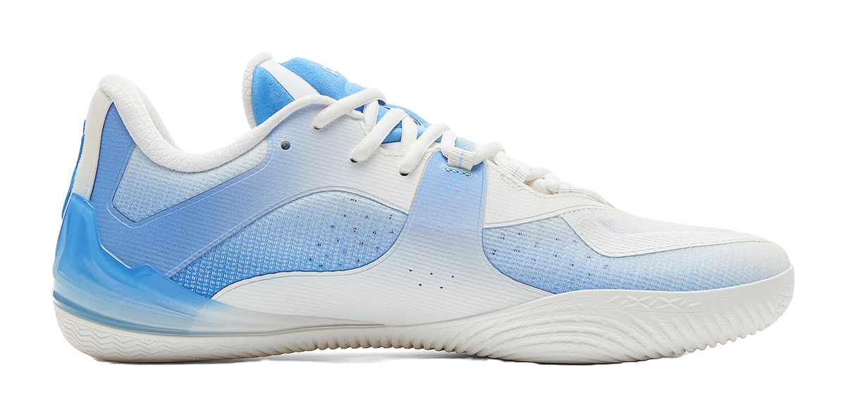 White and blue basketball shoe, side view with textured blue panel and low-cut sole