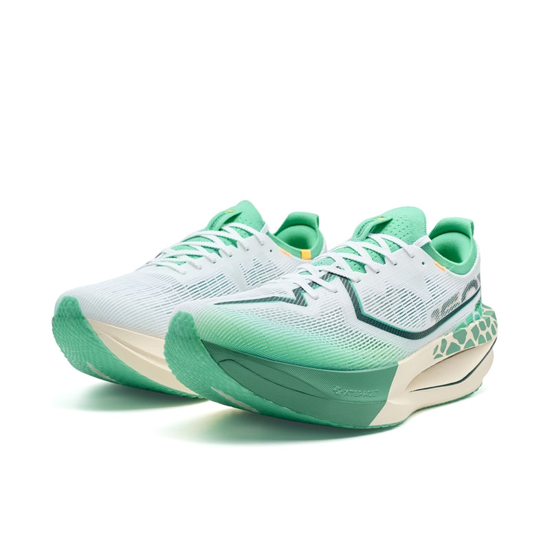Pair of men's running shoes in white and green with lace-up knit uppers