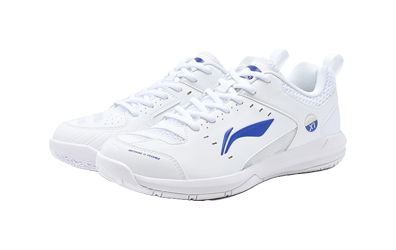 Pair of white badminton shoes with blue logo, lace-up and perforated trim