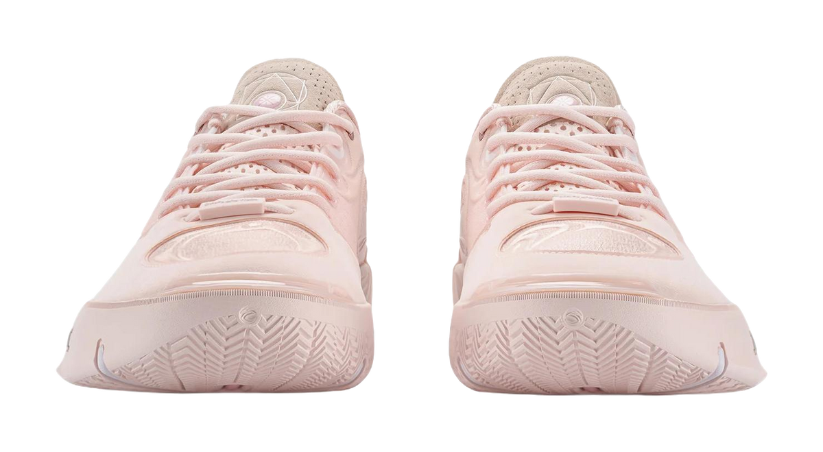 Two light pink basketball shoes viewed from heel, showing outsole tread