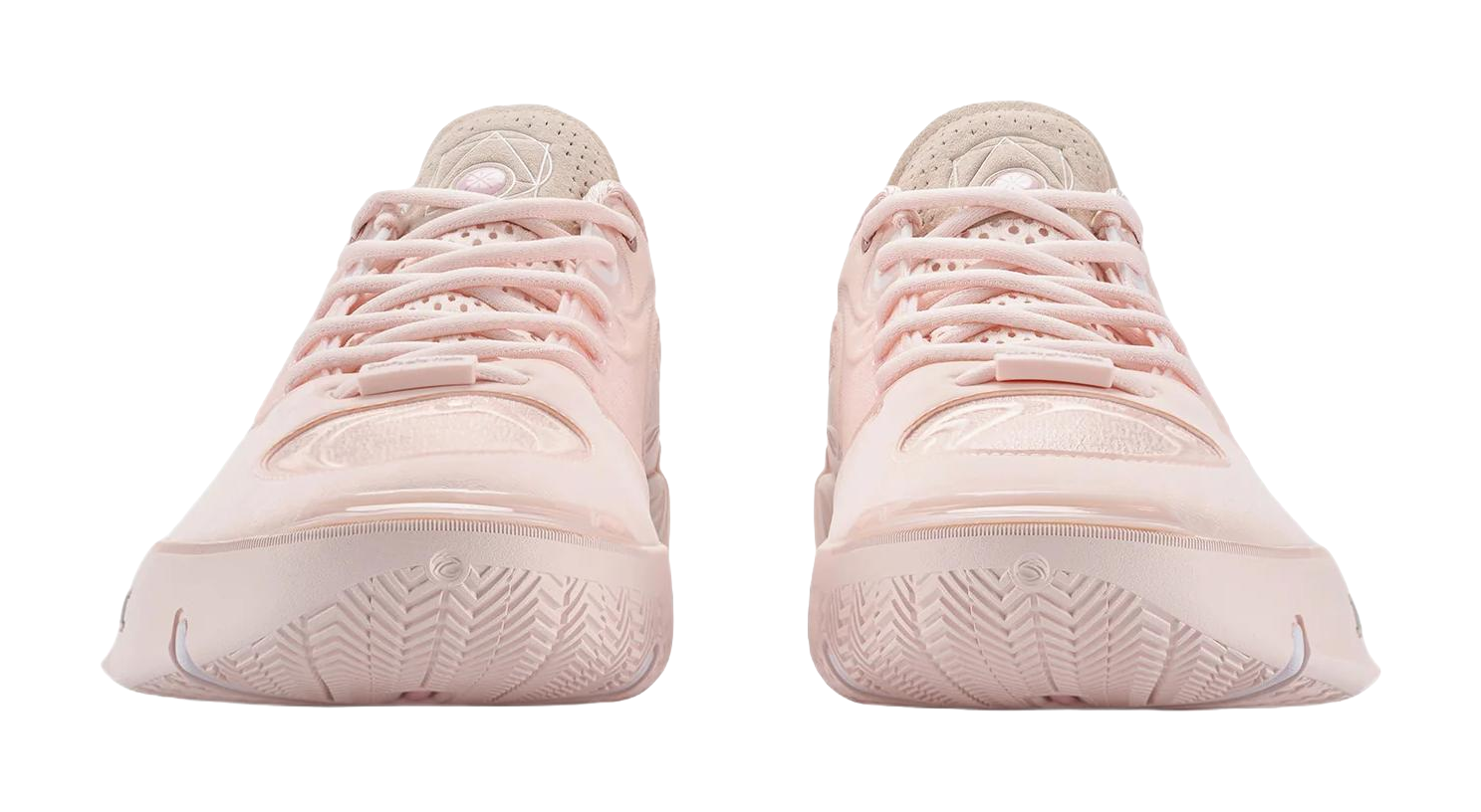 Two light pink basketball shoes viewed from heel, showing outsole tread