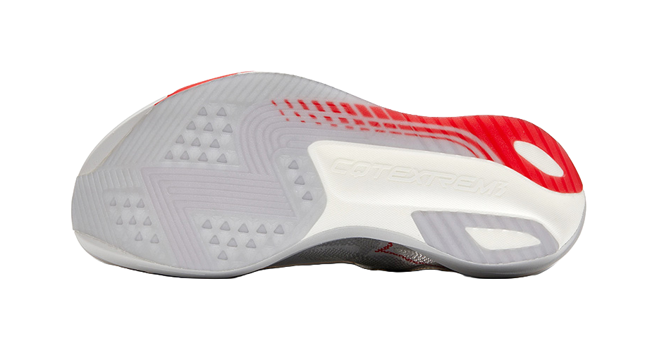 Outsole view of gray running shoe, red traction accents and textured tread