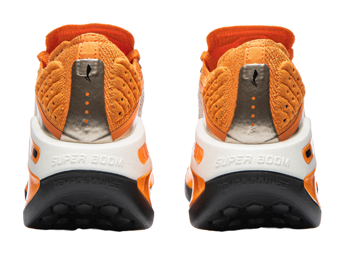 Li-Ning Shadow running shoe heel view with orange upper, white details, and black outsole tread
